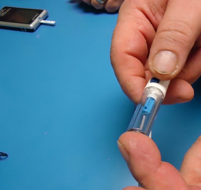 Person preparing a finger-stick glucose check